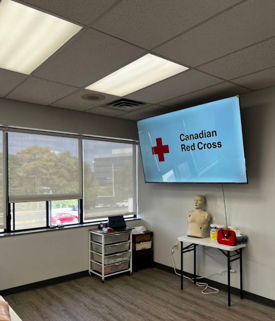 Instructor station at First Aid Connect Kanata with Red Cross presentation screen and training supplies